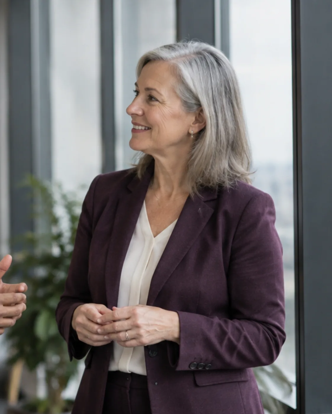 Two colleagues in conversation by an office window